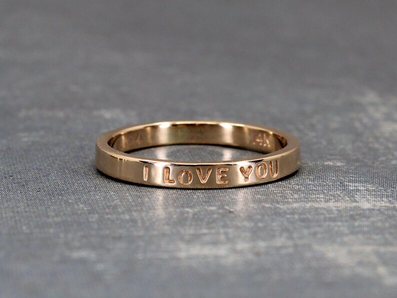 Customized inscription on gold ring. This example shows a ring with the inscription I love you.