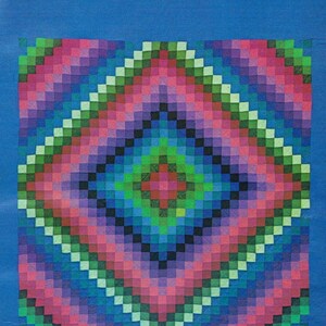 May include: A square quilt featuring a central geometric pattern of small, multi-colored squares in shades of pink, green, blue, and black, arranged in concentric diamond shapes. The quilt is surrounded by a solid, vibrant blue border.