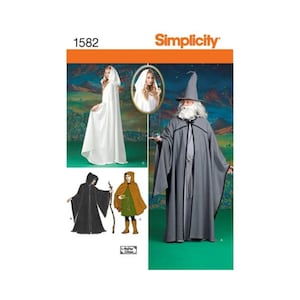 May include: Simplicity pattern 1582 featuring costume designs for hooded cloaks and robes. The illustrations show a white hooded cloak, a black hooded robe, a brown hooded cape with a green tunic, and a grey wizard robe with a matching pointed hat.