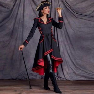 May include: A black long-sleeved coat with red trim, featuring a high-low hemline, gold buttons, and a structured collar. The coat is paired with black leggings, a black tricorn hat with gold accents, a black walking cane, and a gold telescope.