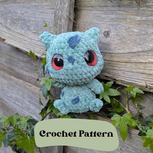 May include: A crochet pattern for a blue and green Bulbasaur plush toy. The toy has red eyes and is sitting on a wooden fence with green vines.