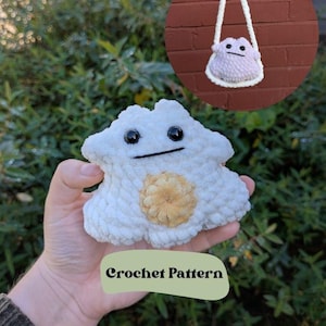 May include: A white crochet cloud-shaped plush toy with black eyes and a smiling mouth, and a tan center. The image also shows a small, round, lavender crochet purse with a white strap. The text "Crochet Pattern" is on the image.