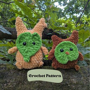 May include: Two plush crochet creatures with leaf-shaped faces and black eyes. One is tan with a green leaf face, the other is brown with a green leaf face. The text "Crochet Pattern" is visible. The background is a natural setting.