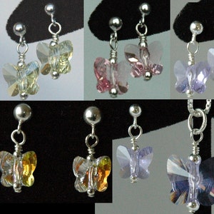 May include: A set of butterfly earrings in various colors, including light blue, green, yellow, pink, and purple. The earrings are made with crystal beads and silver findings.