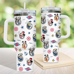 May include: Two white travel mugs with a handle, featuring a pattern of cartoon characters in sailor outfits, red and blue nautical elements, and stars. Each mug has a silver lid and a white straw.