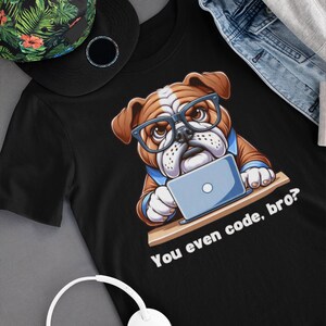 May include: Black t-shirt featuring a cartoon bulldog wearing glasses and using a laptop. The text "You even code, bro?" is printed on the shirt.