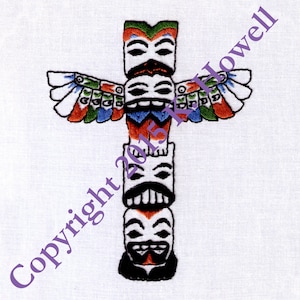 May include: A colorful embroidered totem pole with four faces and a bird with outstretched wings. The totem pole is white with black outlines and the faces have black eyes and mouths. The bird has red, orange, green, and blue feathers.