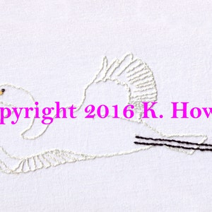 May include: White embroidered image of a bird in flight with a black tail and a yellow beak. The text "Copyright 2016 K. Howell" is below the bird.