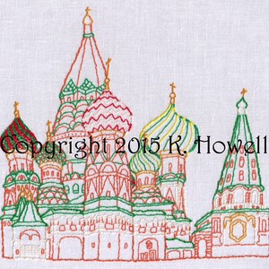 May include: Embroidered image of St. Basil's Cathedral in Moscow, Russia. The cathedral is depicted in red, green, and white with gold accents. The image is on a white background.