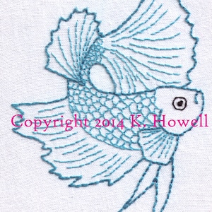 May include: Blue embroidered design of a betta fish with a long flowing tail and fins. The fish is outlined in blue thread and has a small black eye. The background is white.