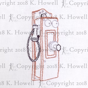 May include: Embroidered design of a vintage rotary phone with a brown wooden body, a black rotary dial, and a black and brown handset. The phone is on a white background.