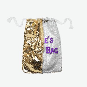 May include: A gold and silver sequin drawstring bag with the text "LE'S BAG" in purple.