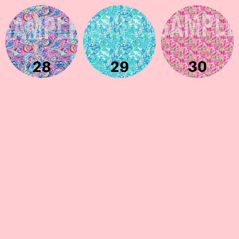 May include: Three circular patterned designs on a pink background. The designs feature colourful paisley, blue floral, and pink rose patterns. Each design has a number: 28, 29, and 30. These are likely fabric or craft designs.