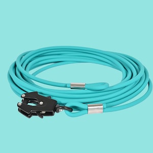 May include: A coiled turquoise rope with a black metal clasp and silver accents. The rope is looped and appears to be made of a flexible material. The background is a solid turquoise color.