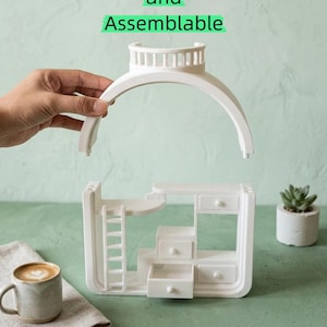 May include: White, detachable and assemblable miniature dollhouse furniture set with a ladder, drawers, and a curved top. The text "Detachable and Assemblable" is displayed above the furniture. A cup of coffee and a small succulent are also in the image.