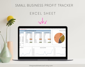 May include: A laptop computer displaying a spreadsheet with a "Yearly Profit Dashboard" title. The spreadsheet includes charts and graphs showing profit, expenses, and sales by month. The spreadsheet also includes a pie chart showing the breakdown of expenses.