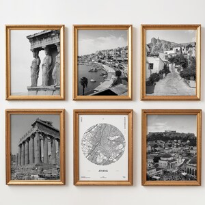 May include: Six framed black and white prints with gold frames. The prints depict Greek architecture, cityscapes, and a map of Athens. The frames are rectangular with a textured gold finish, creating a cohesive gallery wall.