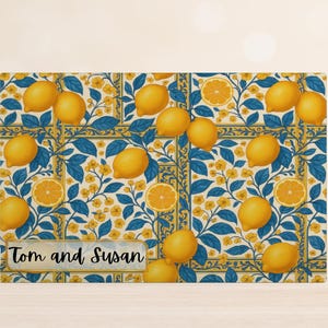 May include: A rectangular card with a lemon-themed design. The pattern features yellow lemons, orange slices, blue leaves, and yellow flowers on a white background. The text "Tom and Susan" is displayed in a marble-like frame.