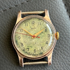 May include: A handmade, wooden cutting board with a natural finish. The board features a live edge on one side and a smooth, rectangular shape. It is ideal for food preparation and serving.