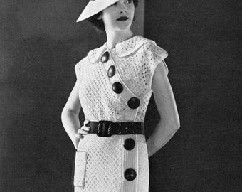 May include: A white crochet dress with a button closure and a belt. The dress is styled with a white hat and white shoes. The image includes text for a knitting and crochet pattern: "772 Sport", "Royal Society Mercerized Knitting & Crochet Cotton", "16 Balls White or Ecru", "22 Balls Color", "Royal Society Eversheen 9 Hanks", "Royal Society Fawn Crepe 30 Balls", "Crochet Hook No. 4", "10 Large Buttons", "1 Belt", "Size 16".