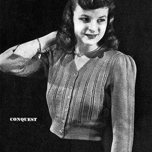 May include: A black and white photo of a woman wearing a knitted cardigan with a button-up front and a v-neck. The cardigan has a delicate lace pattern and is cropped at the waist. The text "CONQUEST" is printed below the woman's shoulder.