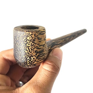 May include: A wooden smoking pipe with a brown and gold patterned finish. The pipe has a round bowl and a long, curved stem.