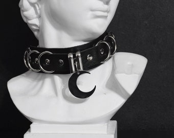 SYRIN CHOKER: Leather eyelet collar with crescent moon pendant and buckle closure