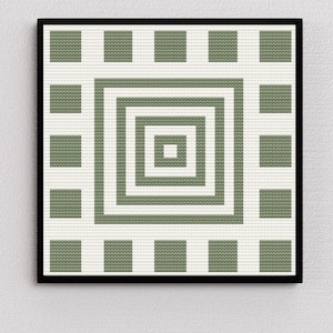 May include: A framed geometric art print featuring a repeating pattern of olive green squares and concentric squares on a white background. The artwork is encased in a black frame, creating a modern aesthetic.