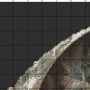 May include: A close-up of a cross-stitch pattern featuring a detailed image of a brown and white dog with a black nose. The dog is looking to the right and has a white patch on its chest. The background is a dark gray color.