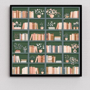 May include: A framed print featuring a detailed illustration of a bookshelf. The shelves are a dark green, filled with books in shades of beige, peach, and brown. Small potted plants and floral arrangements are interspersed throughout the shelves, adding a touch of nature.