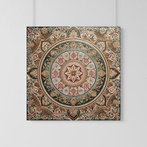May include: A square wall hanging featuring a complex, symmetrical mandala-style pattern. The design incorporates concentric circles with intricate floral motifs, scrolling vines, and geometric shapes in shades of gold, sage green, and deep burgundy.