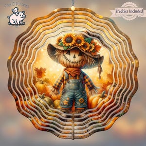 May include: A layered wooden circular decoration featuring a smiling scarecrow wearing a hat decorated with sunflowers. The scarecrow is dressed in overalls and a plaid shirt, surrounded by pumpkins and autumn leaves. The words "Freebies Included" are visible.