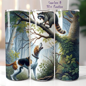 May include: A white tumbler with a colorful illustration of a raccoon and a hound dog in a forest setting. The raccoon is perched on a tree branch, while the hound dog is standing on the ground, looking up at the raccoon. The background is a lush green forest with trees and leaves.