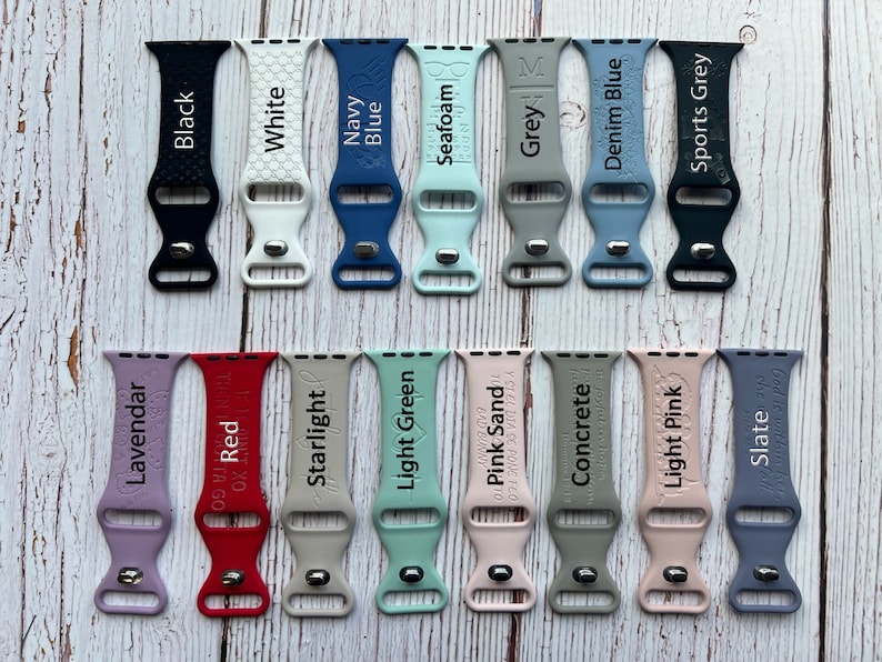 May include: A set of 20 silicone watch bands in various colours, including black, white, navy blue, seafoam, grey, denim blue, sports grey, lavender, red, starlight, light green, pink sand, concrete, light pink, and slate. Each band has a different colour and a different text label.