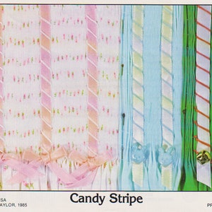 May include: A close-up of a fabric sample card featuring various coloured stripes. The card is labelled "Candy Stripe" and includes the text "PLATE #87 COPYRIGHT IN USA MOLLIE JANE TAYLOR, 1985 PRINTED IN U.S.A."