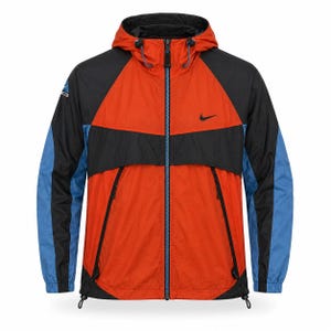 May include: A hooded, color-blocked jacket in orange, black, and blue. The jacket features a black Nike swoosh logo on the chest and a full-length zipper. The sleeves are blue and black, with a drawstring hood and hem.