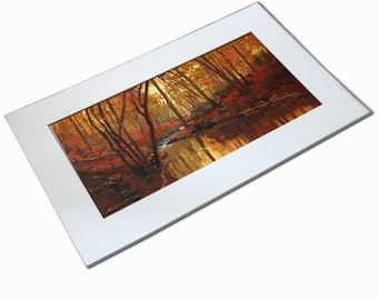 May include: An autumn landscape painting featuring a forest scene with a stream. The artwork is framed with a white mat. The painting showcases trees with orange and red leaves, reflecting in the water, creating a warm, inviting atmosphere.
