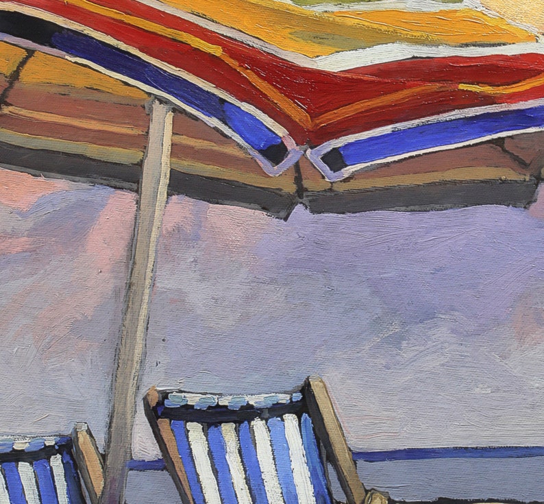 May include: A striped beach chair with a blue and white pattern sits under a red, yellow, and blue striped beach umbrella. The umbrella is partially open and the chair is facing away from the viewer.