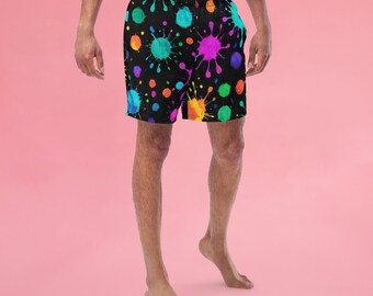 May include: Black swim trunks with a colorful paint splatter pattern.