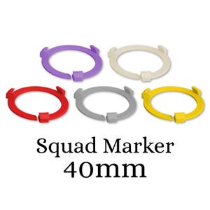 May include: Five different coloured plastic rings, 40mm in diameter, for use as squad markers. The rings are purple, red, grey, yellow, and white.
