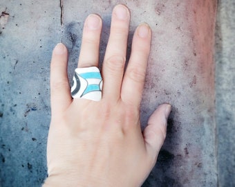 Unieke upcycled statement ring, handgemaakt van gebroken serviesgoed met een roestvrijstalen band. Blauw, wit en zwart.