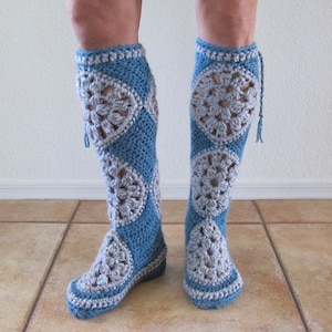 May include: A pair of blue and white crocheted knee-high socks with a lacy pattern.