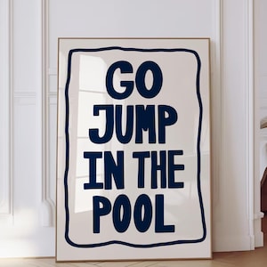 May include: A white poster with a black border and the text "GO JUMP IN THE POOL" in a bold, blue font.