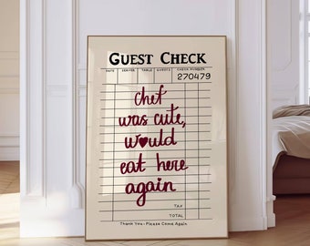May include: A white guest check with red text that reads "GUEST CHECK" and "270479". The text "chef was cute, would eat here again" is written in red cursive on the check.