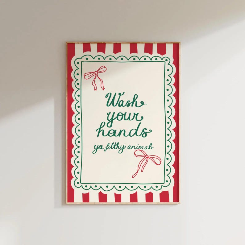 May include: A framed art print with a red and white striped border and a scalloped green edge. The text "Wash your hands ya filthy animal" is written in green script, with red bow accents.