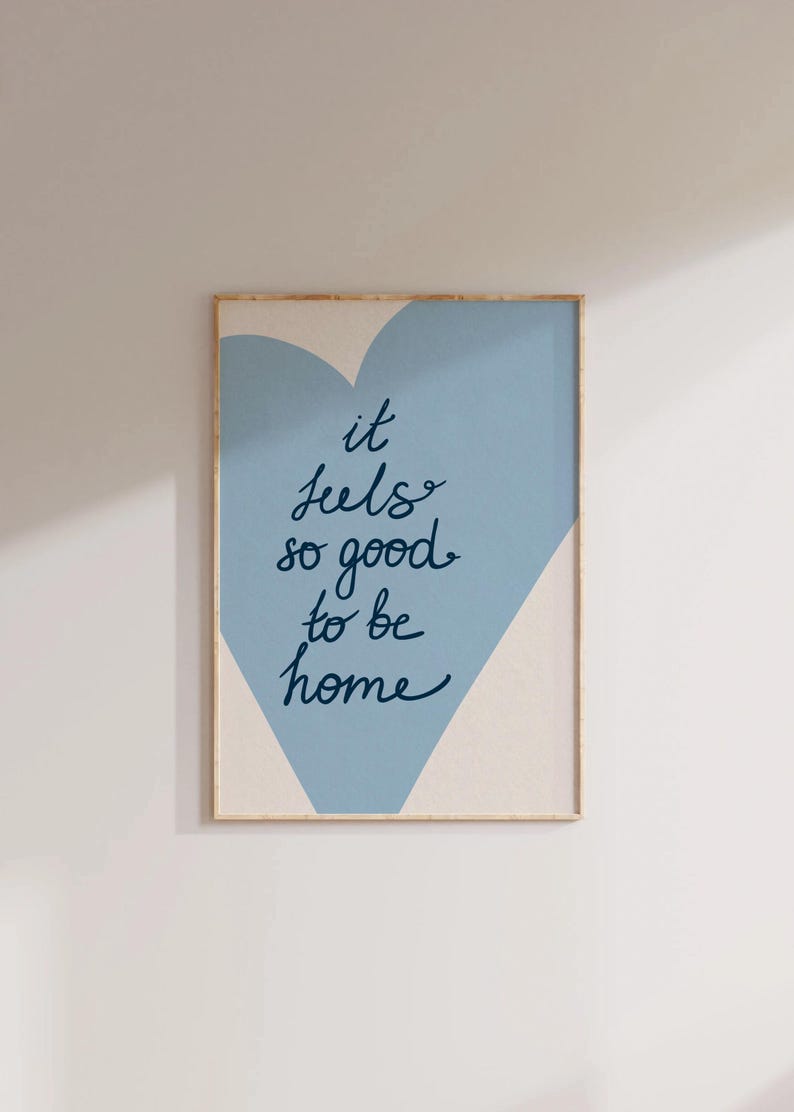 May include: A blue and white heart-shaped print with the text "it feels so good to be home".