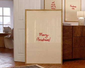May include: Three framed art prints with holiday-themed text. The largest print reads "Merry Christmas!" in red script. Two smaller prints say "eat, drink and be merry!" and "Christmas vibes" in red. The frames are light brown.