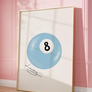 May include: A blue and white illustration of a pool ball with the number 8 on it. The text "Lucky" is written below the ball.