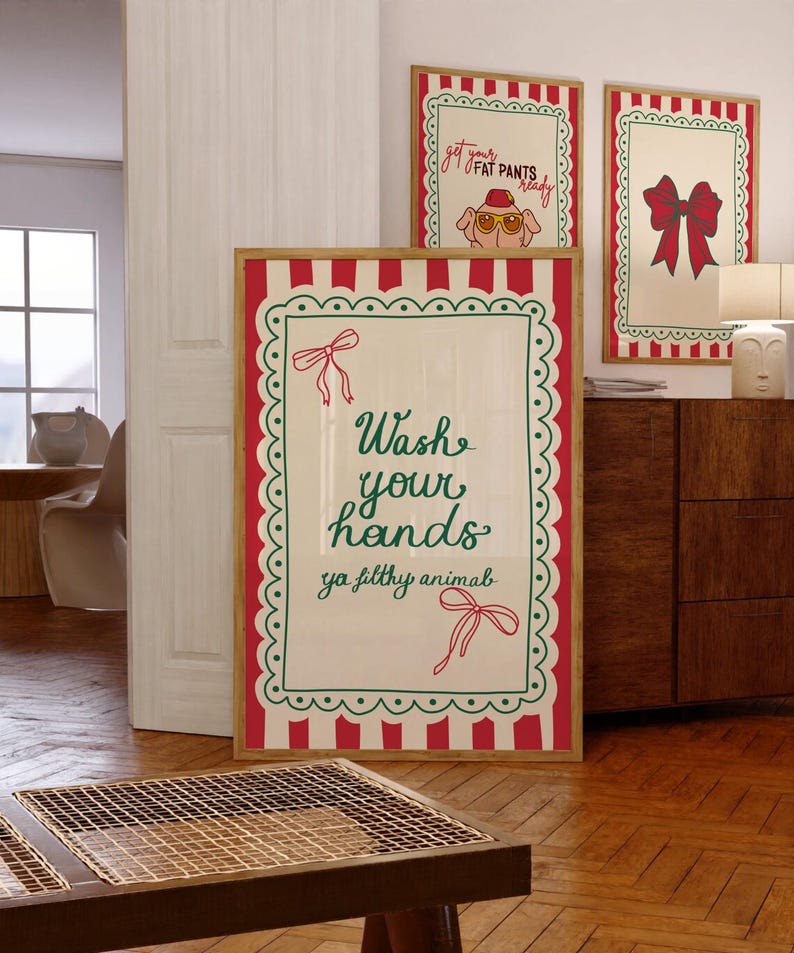 May include: Three framed art prints with a festive theme. The largest print reads "Wash your hands ya filthy animal" in green script. Two smaller prints feature a pig in sunglasses and a red bow. All prints have a red and white striped border.