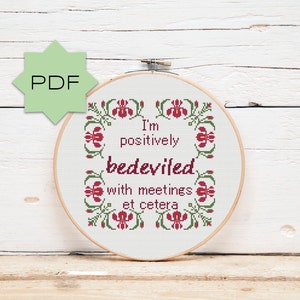 May include: Cross stitch pattern featuring a floral border and the text "I'm positively bedeviled with meetings et cetera".
